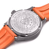 Close up shot of the caseback of the Oak & Oscar Humboldt SAR BWCA on orange rubber strap