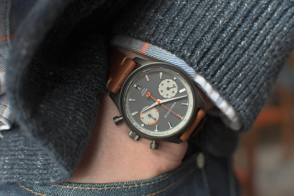 wrist wearing the Jackson Flyback designer watch in grey from Oak & Oscar