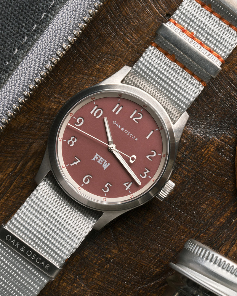 Overhead shot of the Oak & Oscar Olmsted FEW limited edition sitting on wood board with grey nylon strap