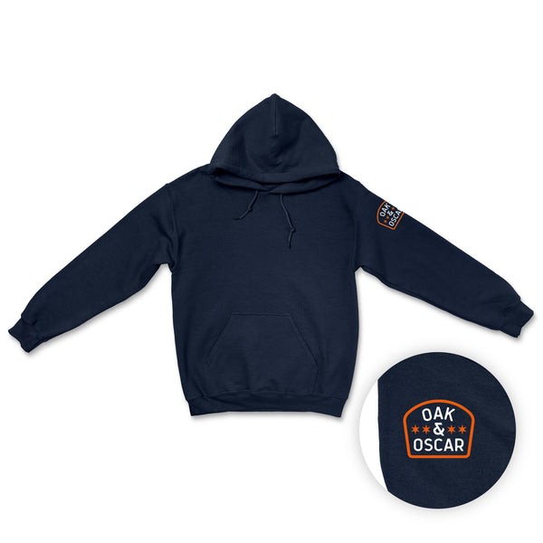 Navy blue hoodie with a printed patch on the sleeve and a matching cap on a white background