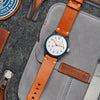 Oak & Oscar Batch No 2 on orange Horween leather strap laying on open canvas watch wallet